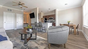 Eine moderne Wohnung mit Wohnzimmer, Essbereich und Küche.