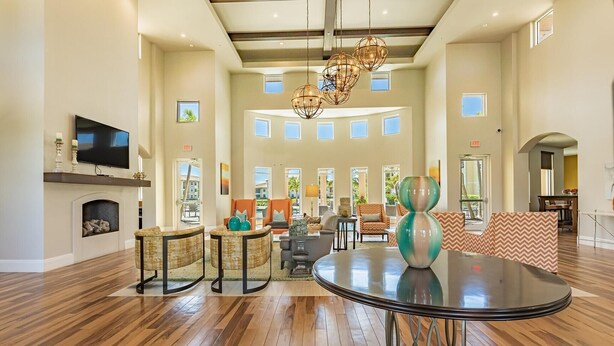 A spacious living area with a fireplace, multiple seating options, and a large round table. - Landing | Incredible 2BD, Courtyard, Yoga Studio (Fort Myers)