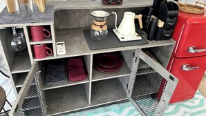 A compact kitchen area with a coffee maker, kettle, and various utensils. - Roadside Mongolian Yurt (Teasdale)