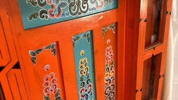 A door with intricate decorative patterns and a blue and orange color scheme.