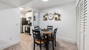 A modern kitchen with white cabinets, a stainless steel refrigerator, and a built-in oven. - Modern UF Apartment ON Archer Rd Near Shands & VA (Gainesville)
