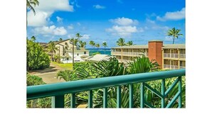 A resort with multiple buildings, a pool, and palm trees. - Partial Ocean View 1BR +Queen Sleeper Sofa, Prime Location 
Family Friendly (Kapaa)