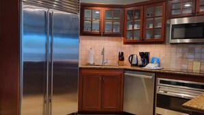A modern kitchen with stainless steel appliances, wooden cabinets, and a tiled backsplash. - Partial Ocean View 1BR +Queen Sleeper Sofa, Prime Location 
Family Friendly (Kapaa)