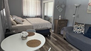 A cozy bedroom with a bed, bedside table, and a dresser. - Stay in style and comfort (central location) (Tampa)
