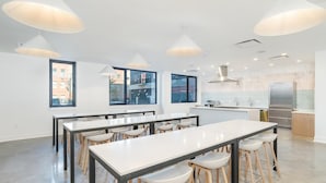 A modern kitchen with white countertops, stainless steel appliances, and pendant lighting. - Landing | Chic 1BD, Clubhouse, Rooftop Lounge (Philadelphia)