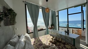 A bedroom with a large bed, a desk, and a view of the ocean. - 2 Manolo Pris Studio Private Terrace (El Pris)