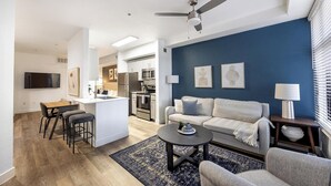 A modern apartment with a kitchen, dining area, and living room.