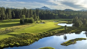 A golf course with a pond, trees, and a mountain in the background. - Black Butte Ranch Golf Course Condo 081 (Black Butte Ranch)