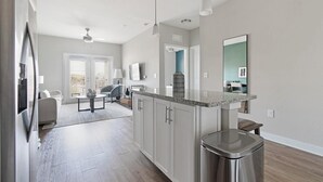 A modern kitchen with granite countertops, stainless steel appliances, and a central island. - Landing | Incredible 1BD, Gym, Clubhouse (Nocatee)