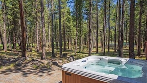 A hot tub in a forested area with a paved path leading to it. - Black Butte Ranch Glaze Meadow 223 (Black Butte Ranch)