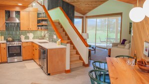 A modern kitchen with wooden cabinets, a built-in stove, and a large island. - Black Butte Ranch Lodge Condo 014 (Black Butte Ranch)