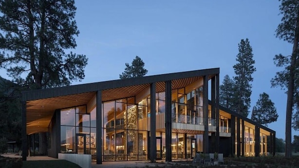 A modern building with large windows, a flat roof, and a wooden deck. - Black Butte Ranch Lodge Room 020 (Black Butte Ranch)