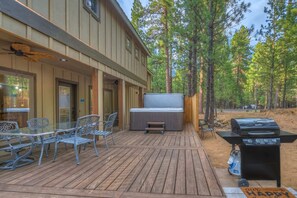 A deck with outdoor furniture, a grill, and a large screen. - Black Butte Ranch South Meadow 072 (Black Butte Ranch)