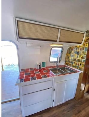 Fridge, microwave, coffee/tea maker, cookware/dishes/utensils