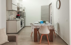 Fridge, stovetop, dishwasher, coffee/tea maker