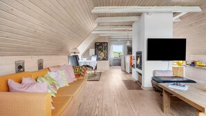 A cozy, wooden interior with a sofa, a TV, and a fireplace. - Beautiful home in Hvide Sande with WiFi (Hvide Sande)