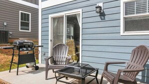 A patio with a grill, two Adirondack chairs, and a table. - White Pine Sycamore by Avantstay Near Downtown (Asheville)