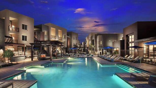 A modern hotel with a central pool, outdoor seating, and a covered area. - Landing | Stylish 1BD, Gym (Glendale)