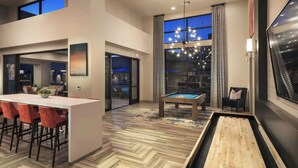 A modern interior with a pool table, bar area, and a billiards table. - Landing | Stylish 1BD, Gym (Glendale)
