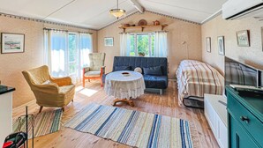A cozy living room with a sofa, armchair, and round table. - 1 bedroom beautiful home in Ljungskile (Ljungskile)