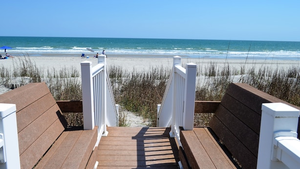A wooden boardwalk leading to a beach with white railings and benches. - Sandfiddler 301 - Oceanfront Condo in Surfside Beach (Surfside Beach)