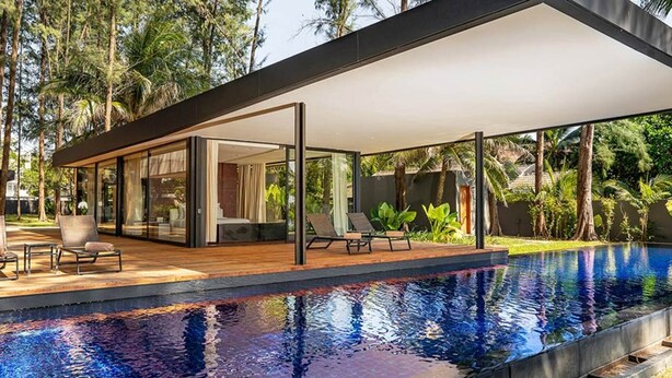 A modern outdoor pool area with a covered patio, lounge chairs, and a view of the surrounding tropical landscape. - At Last You and Your Friends Can Rent a Luxury Villa with 24/7 Concierge (Chang Wat Phang-nga)