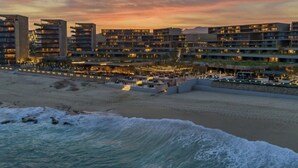A coastal hotel with multiple buildings, a beachfront promenade, and a sandy beach. - Luxury Ocean View Villa-Los Cabos at Solaz Resort (San José del Cabo)