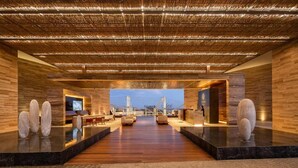 A spacious lobby with a wooden floor, a large seating area, and a television screen. - Luxury Ocean View Villa-Los Cabos at Solaz Resort (San José del Cabo)