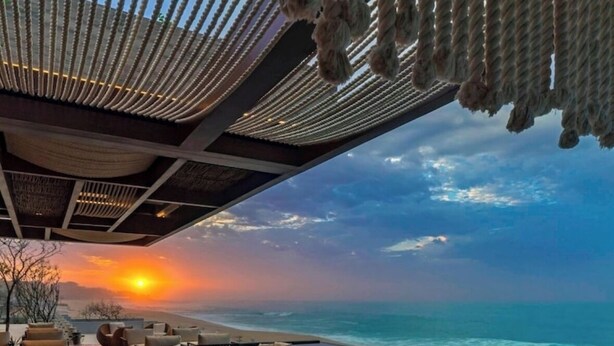 A wooden deck with outdoor seating overlooking a beach at sunset. - Luxury Ocean View Villa-Los Cabos at Solaz Resort (San José del Cabo)