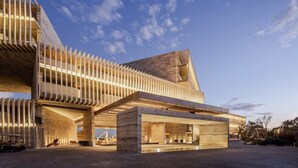 A modern building with a unique architectural design, featuring a prominent overhanging structure and a spacious entrance area. - Luxury Ocean View Villa-Los Cabos at Solaz Resort (San José del Cabo)