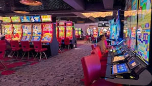 A casino with multiple slot machines, red chairs, and a carpeted floor. - Candlewood Suites Stafford - Quantico by IHG (Stafford)