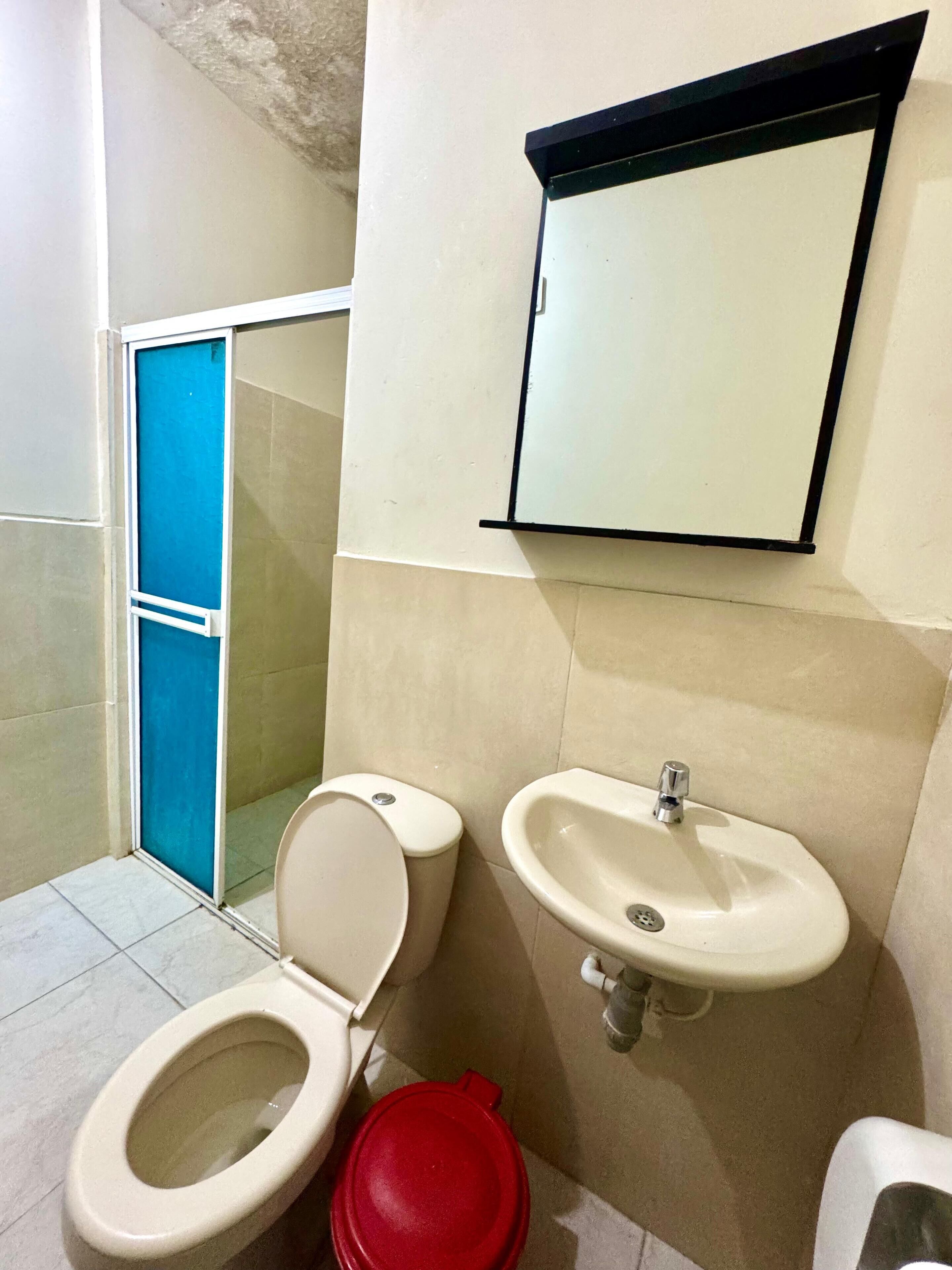 A bathroom with a toilet, bidet, and sink.
