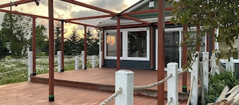 Drift into comfort at the Cozy Current. Your lakeside escape awaits you!