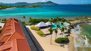 A resort with a swimming pool, beach, and ocean views.