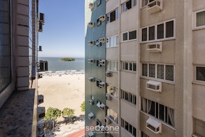 A high-rise building with multiple air conditioning units, a beach view, and a distant island. - Beachfront apt BC Center Close to Attract. Eal0704 (Balneário Camboriú)