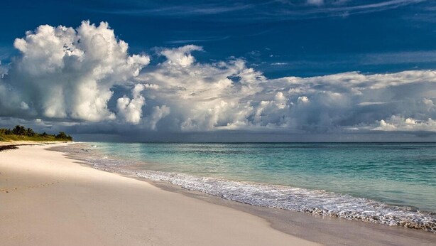 A beach with a clear sky and large clouds. - Brand new 2-bedroom cottage, Harts Exuma across the street from the beach (Exuma)