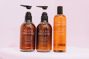 Three bottles of Allna Organic products: shampoo, treatment, and body soap. - 3BD Yuzawa Onsen Lodge House A (Minamiuonuma)