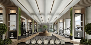 A modern hotel lobby with a central seating area, workout equipment, and a large mirror. - Intercontinental Changchun High Tech Zone (Changchun)