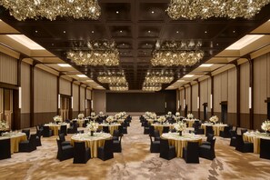 A large banquet hall with round tables, black chairs, and chandeliers. - Intercontinental Changchun High Tech Zone (Changchun)