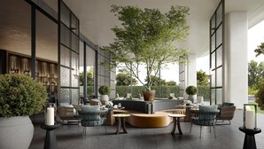 A modern outdoor seating area with a large tree, comfortable seating, and a bar area. - Intercontinental Changchun High Tech Zone (Changchun)