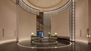 A spacious lobby with a curved ceiling, a central reception desk, and a polished floor. - Intercontinental Changchun High Tech Zone (Changchun)