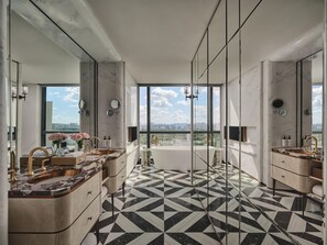 A modern bathroom with a large bathtub, two sinks, and a large mirror. The floor has a black and white geometric pattern. - Intercontinental Changchun High Tech Zone (Changchun)