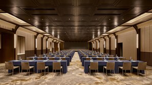 A conference room with multiple tables and chairs, equipped with water bottles and nameplates, in a modern hotel setting. - Intercontinental Changchun High Tech Zone (Changchun)