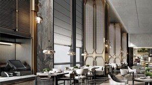 A modern restaurant with high ceilings, large windows, and a mix of seating arrangements including tables and chairs. - Intercontinental Changchun High Tech Zone (Changchun)