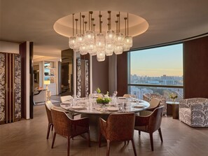 A modern dining area with a round table, multiple chairs, and a chandelier. - Intercontinental Changchun High Tech Zone (Changchun)