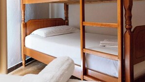 A bunk bed with wooden frames and white bedding. - Hotel Nika Radhime (Vlorë)
