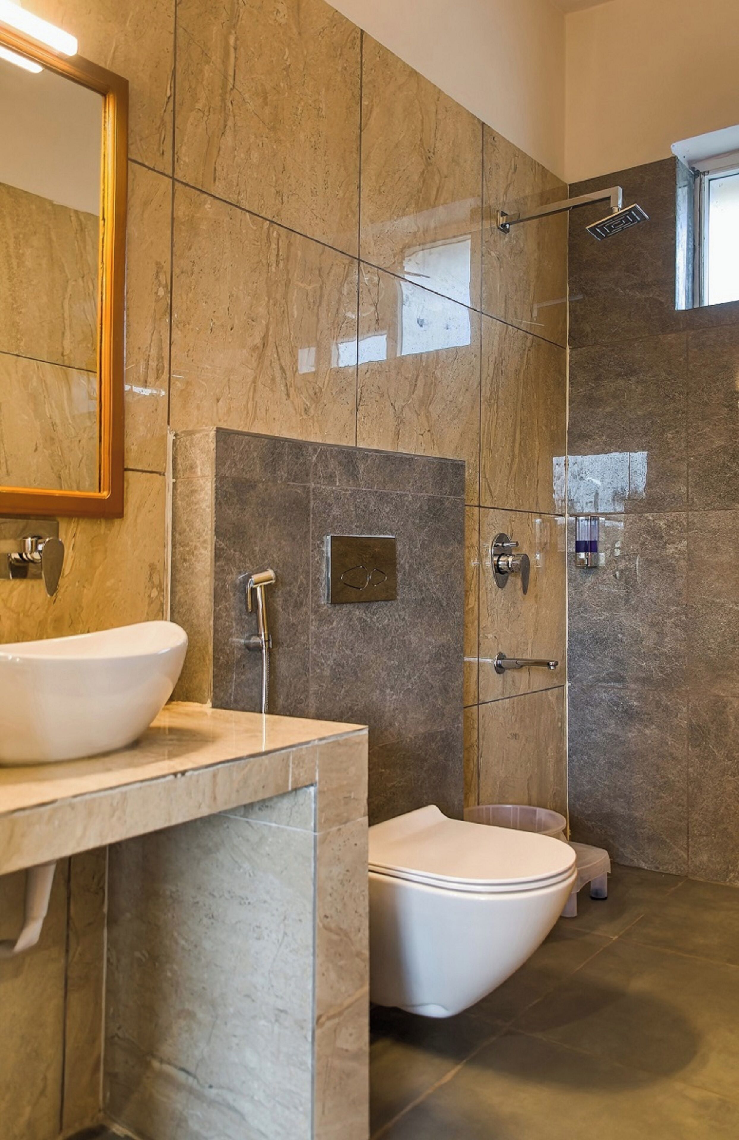 A modern bathroom with a freestanding bathtub, a toilet, and a shower.