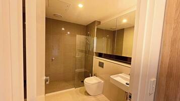 Shower, hair dryer, soap, toilet paper