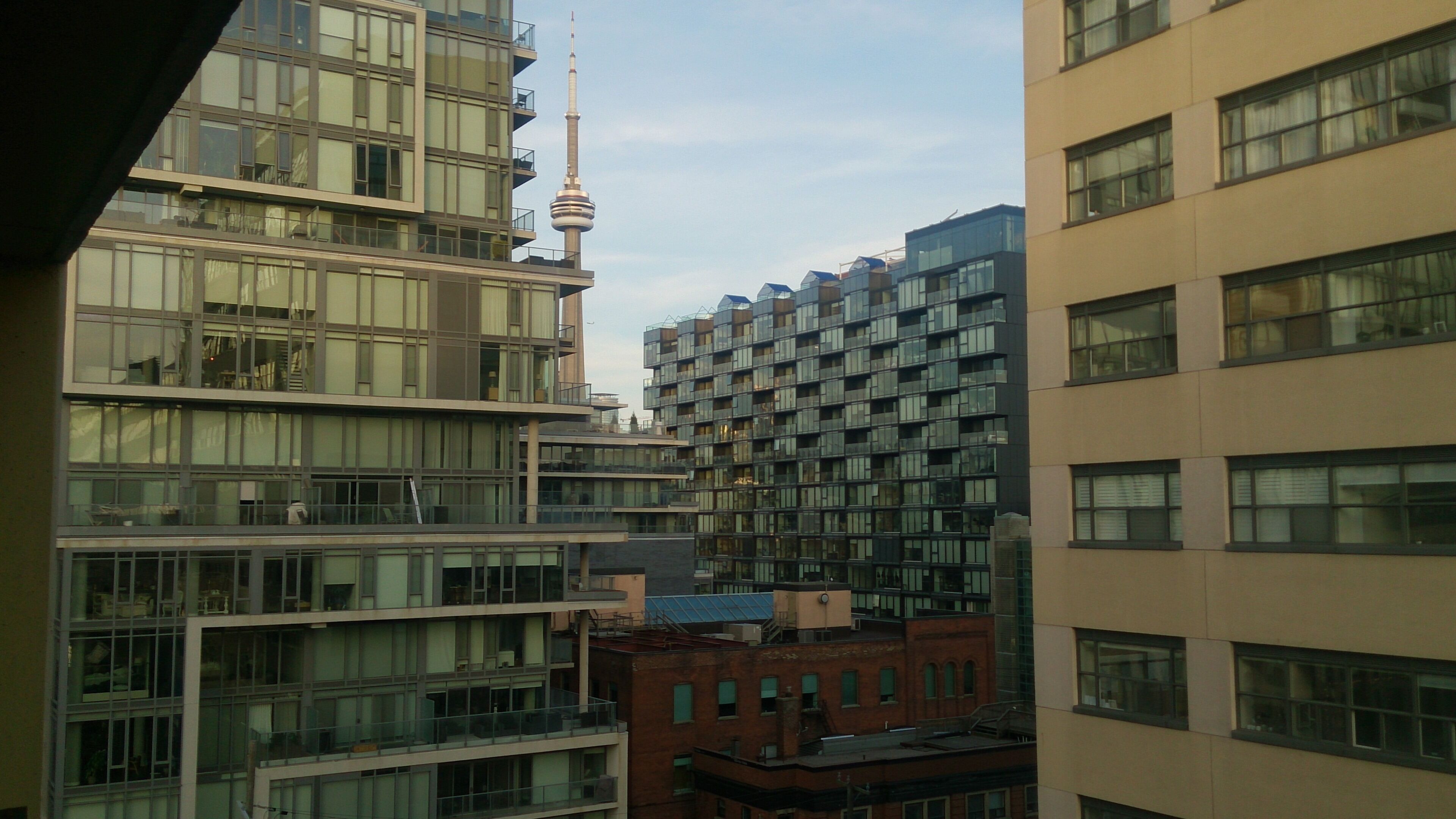 A high-rise building with multiple floors, large windows, and a prominent tower structure.
