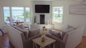 A living room with a sofa set, a coffee table, and a fireplace. - New renovation Moon River (Marine City)